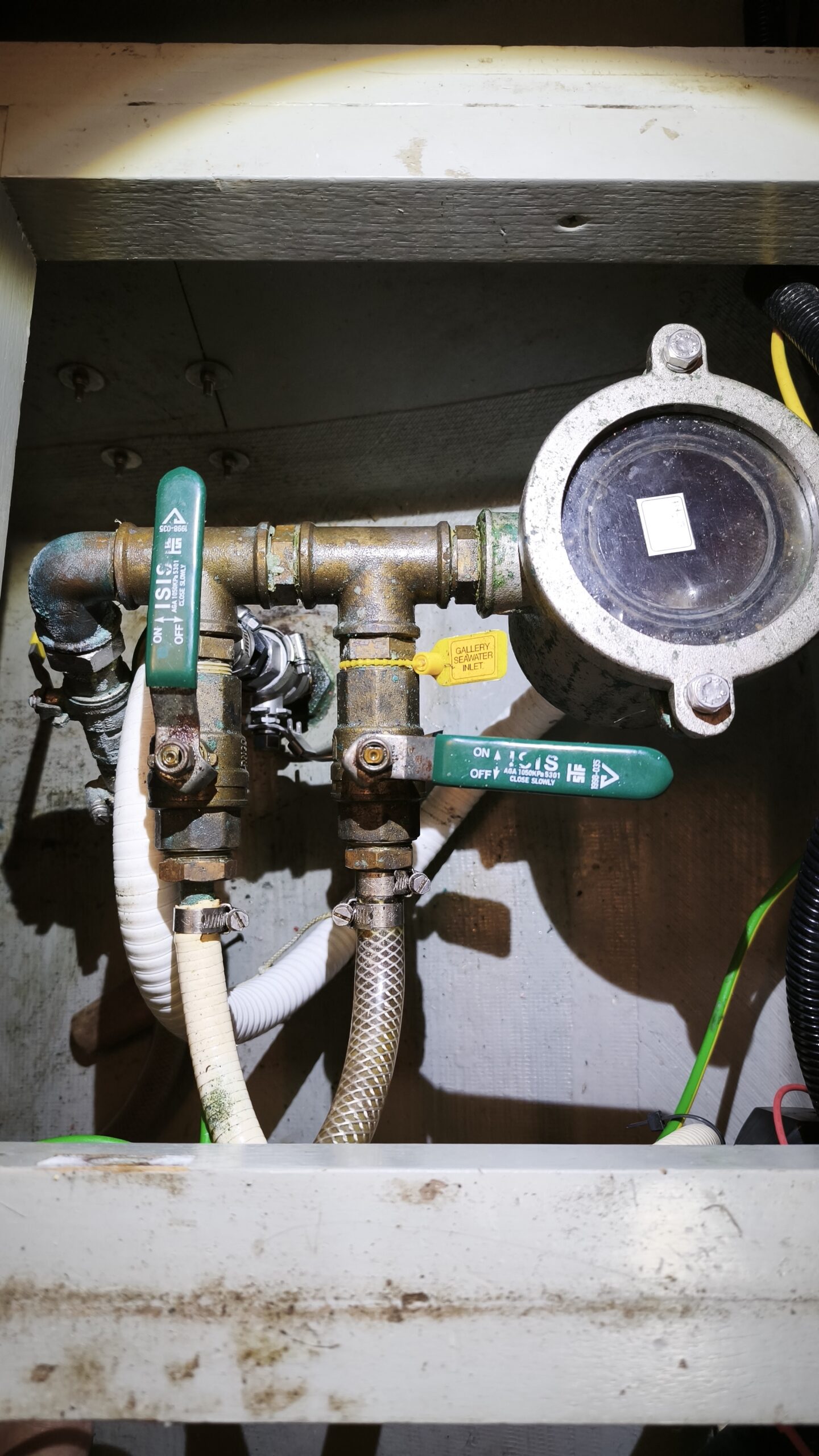 Valve and hose connections inspected in a technical compartment aboard PRANIS